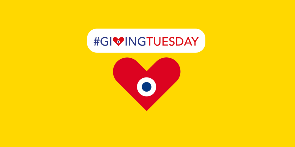 Hashtag Giving Tuesday, avec un coeur rouge contenant un point bleu au milieu (symbole du coeur Giving Tuesday)